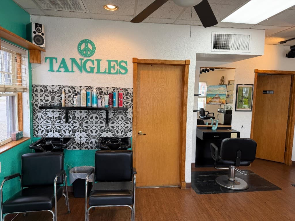 Tangles Salon — wash stations and styling area with teal branding